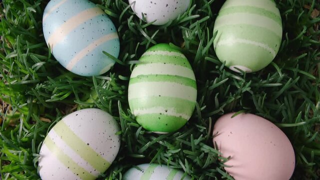 Assorted decorative Easter eggs nestled in vibrant green grass spring