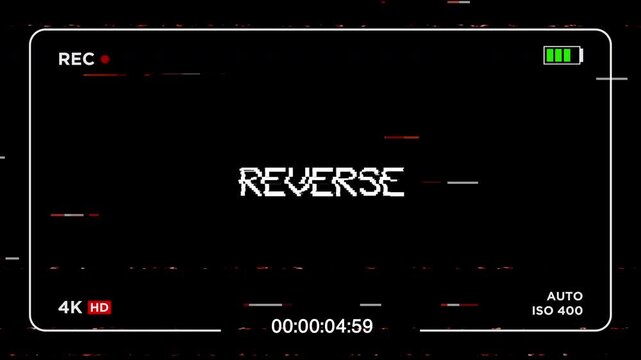 VHS reverse text animation with camera viewfinder screen and analog glitch distortion. 