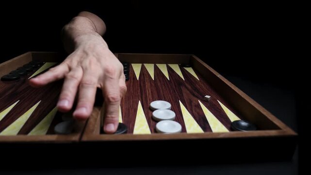 Close-up of Backgammon Board, Hand Waiting for Opponent to Make a Move