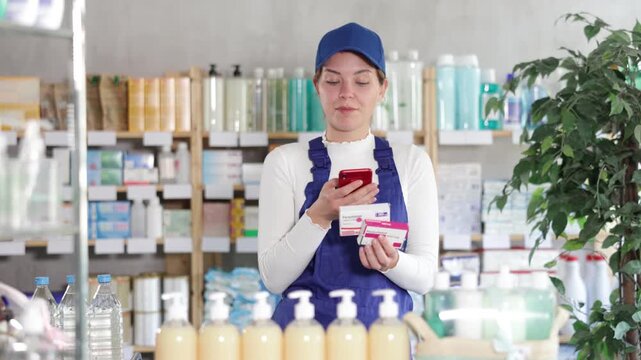 Laborer young woman in pharmacy scans QR code on paracetamol pills and uses link to go to manufacturers website. Dietary supplements, replenishment of vitamin and microelement deficiencies.