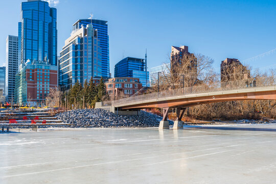 View of high rise buildings in Downtown Calgary across frozen River Bow. Winter in Canada