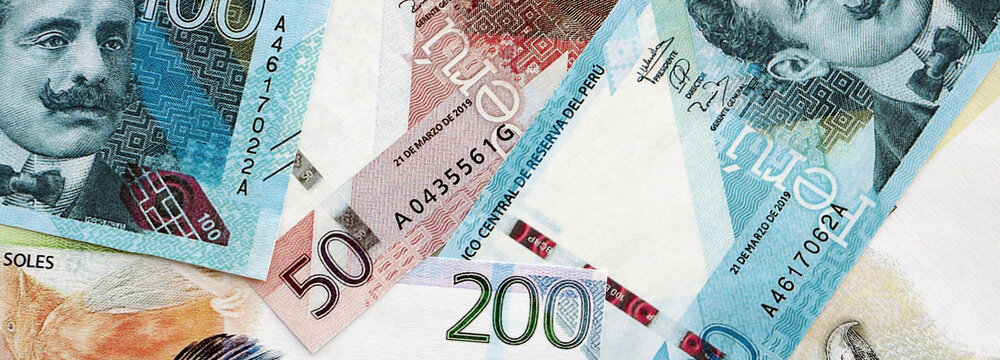 Peruvian sol paper banknotes pile on table. Peru PEN currency money bills in big amount. Concept of economics, taxation and banking in Peru