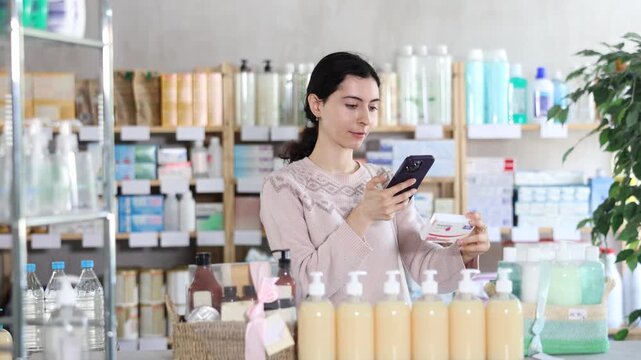 Girl in autumn clothes scans code on package of paracetamol pills to check the expiration date. High quality 4k footage