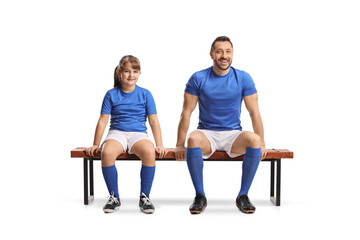 Obraz premium Adult football player and a girl sitting on a bench