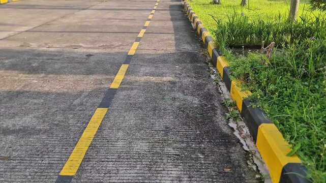 A clean concrete industrial road featuring textured surface and vibrant road paint. Perfect for logistics, transportation, and civil engineering themes.