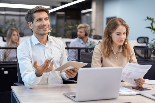 Friendly and helpful customer service support specialists in work.