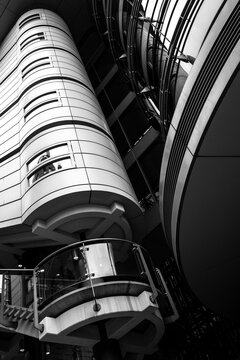 Modern industrial architecture with metal pipes and cylinder structure in monochrome shows high contrast and dramatic perspective for infrastructure detail