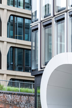 Modern urban building facade with windows and curve glass exterior showing bold geometry in contemporary architecture detail and perspective
