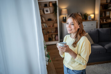 Young woman enjoying morning coffee at home