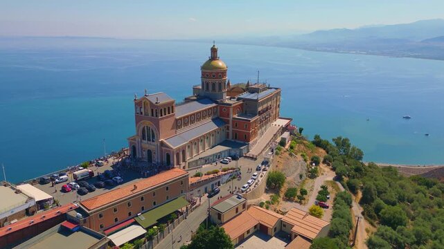 Aerial drone view of the Sanctuary of Tindari in Sicily, overlooking the stunning Mediterranean coast and lagoons. A breathtaking blend of history, faith, and Sicilian landscape from above.
