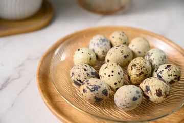 Fototapeta premium The fresh quail eggs on the plate on the table