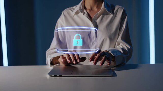 Typing on laptop shows hologram lock. Hands hover above laptop. Blue padlock icon indicates data security. Concept emphasizes cybersecurity privacy encryption technology. Interface suggests