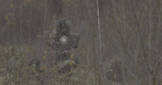 Old Stone Cross In Ancient Graveyard. Slavic Orthodox tombs burials. Babtsy, Vitebsk Region, Belarus. Ungraded C-LOG 2, ungraded, canon c-log.