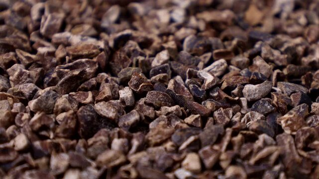 Roasted brown crushed cocoa nibs texture circle rotation close up