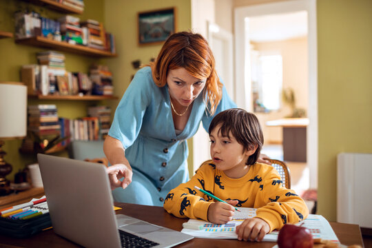 Parent helping child with homework at home