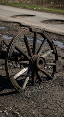 Fototapeta premium Burned Wooden Wagon Wheel on Dusty Ground