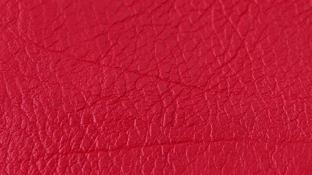 Bright red leather texture circle rotation close up