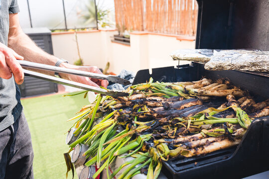 fresh calcots on grill prepared grilled calcots, traditional food of catalonia in spain