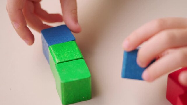 child 5 years old stacking blocks, Building castles, playing educational wooden geometric figures, childhood earlier child development, Educational play toy blocks develops motor and thinking skills