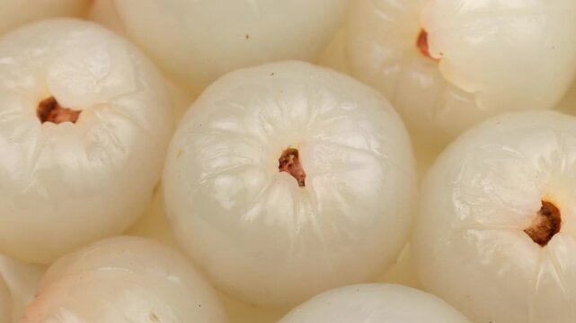 Peeled lychee pulp circle rotation close up