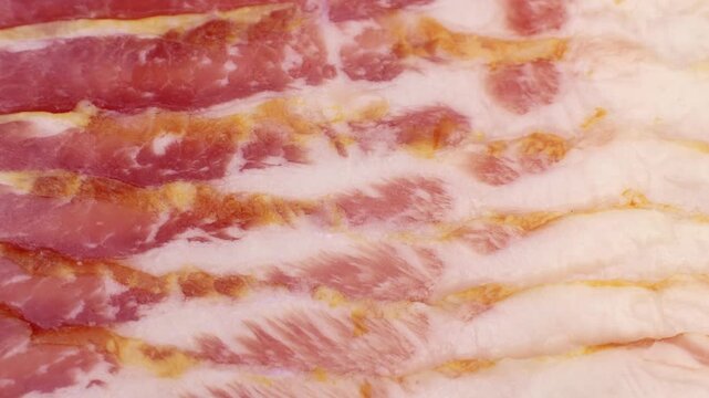 Fresh raw bacon slices circle rotation close up