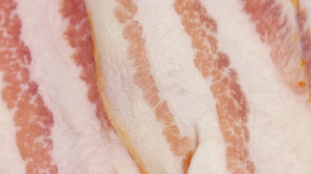 Fresh raw bacon slices circle rotation close up
