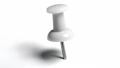 A close-up of a white thumbtack with a silver pin, casting a shadow