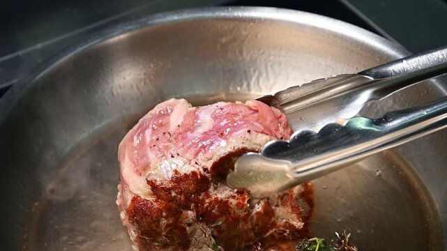 Beef steak cooking in pan with herbs, showing progression of searing process