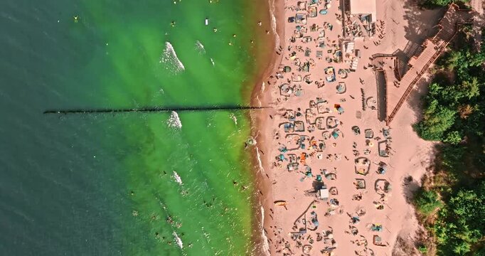 View from above sea and crowd on beach in summer.