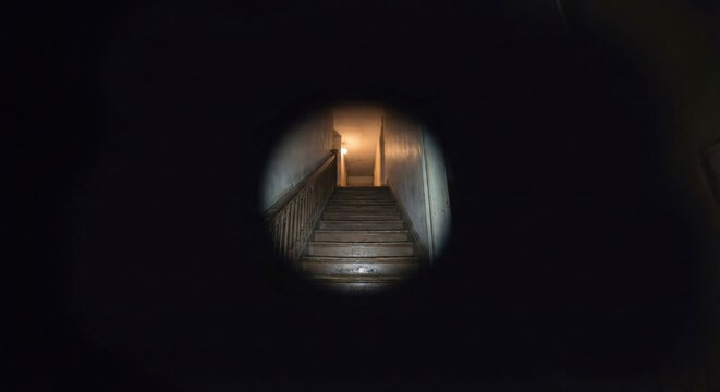 POV of dark stairs with tunnel vision simulating glaucoma