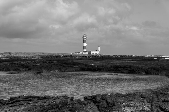 Faro del Toston lighthouse volcanic lagoon El Cotillo Fuerteventura Canary Islands Atlantic coast black white landscape
