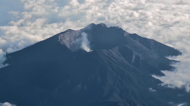 View from Mount Rinjani summit looking down at the smoking Barujari active volcano cone