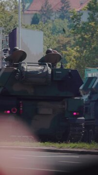 Military parade. Army vehicles marching down the streets. The KTO Rosomak is a family of eight-wheeled armored fighting vehicles derived from the Finnish Patria AMV.