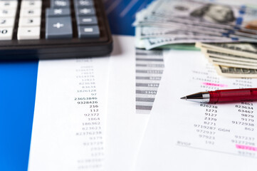 Business and financial background with dollars data, pen and calculator Book keeping background
