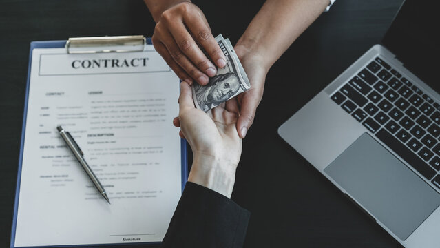 hand receiving bribe money from business man the concept