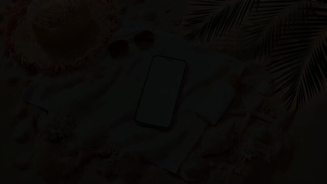 A Relaxing Beach Setup Featuring a Smartphone, Sunglasses, Sunscreen, and Shells on a Sandy Towel Surrounded by Natural Beauty and Tropical Vibes