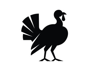 Fototapeta premium A simple black silhouette of a turkey, standing with its tail fanned out. The image is isolated on a clean white background, making it suitable as an icon or graphic for Thanksgiving or fall themes.