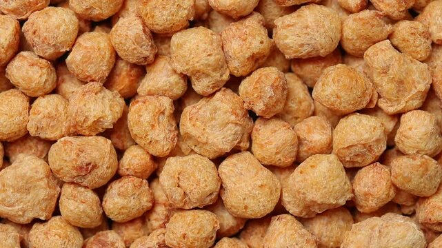 Slowly rotating dry textured vegetable protein (TVP) or soy meat. a plant-based meat substitute