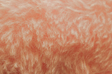 Soft pink plush fabric background with long fuzzy fibers, macro shot of delicate textile surface for romantic design or beauty backdrop © moryachka