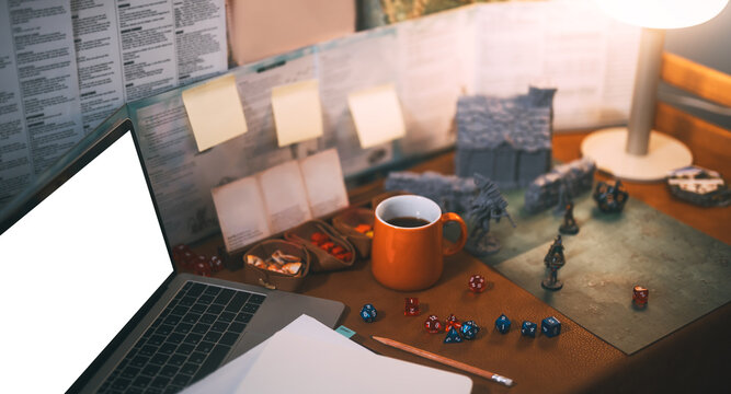 On table dungeon map and building story with white screen mockup laptop old school game style role playing game concept