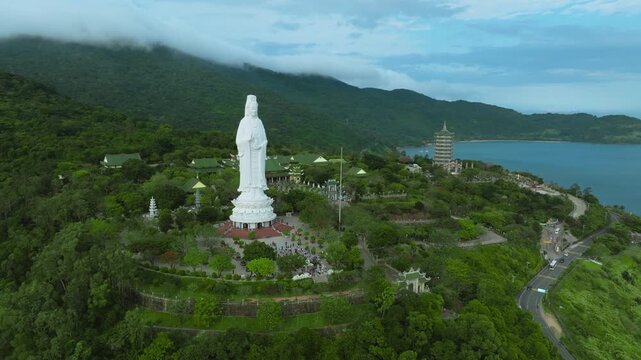 Aerial View of the Lady Buddha Statue and Linh Ung Pagoda in Da Nang, Vietnam
reveals the majestic white statue overlooking the ocean and the city of Da Nang, Vietnam