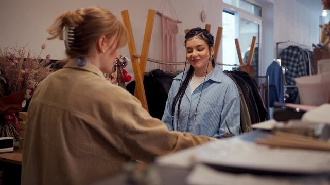 Friendly Staff Talking With Customer At Boutique Counter, Warm Smile And Order Packing Interaction