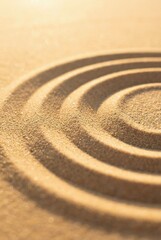 Naklejka premium Zen sand garden with concentric circles representing mindfulness and spiritual balance in golden sunlight.