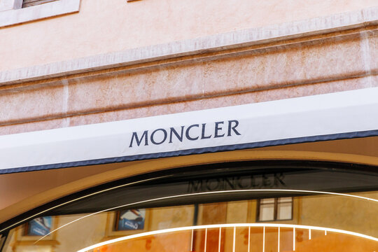 Cortina D Ampezzo, Italy - March 07, 2026: Moncler storefront sign displayed prominently above an entrance with elegant architectural details and reflections visible in the glass