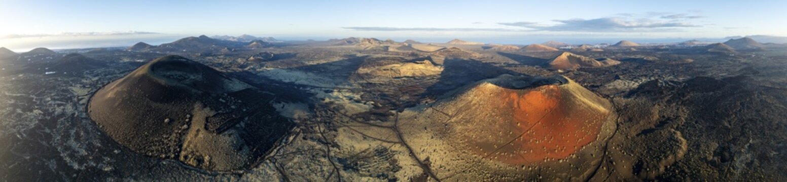 Picturesque volcanic landscape with volcanic craters and lava fields in morning light, Monta&ntilde;a Negra volcano, Caldera Colorada and Volc&aacute;n de Las Nueces, Los Volcanes Natural Park, aerial view, Lanzarote, Canary Islands, Spain