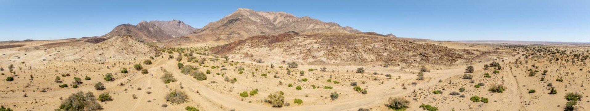Aerial view, dry riverbed and desert landscape on the Ugab River, behind Brandberg, Erongo, Damaraland, Namibia