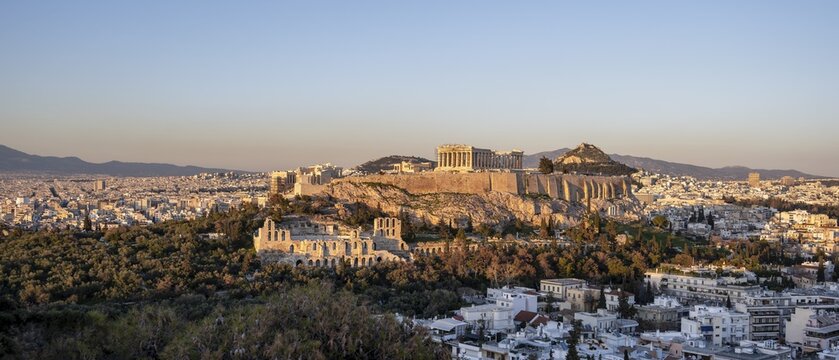 View from Philopappos Hill over the city at sunset, panorama of the Parthenon Temple and Herod's Amphitheatre, Acropolis, Athens, Greece