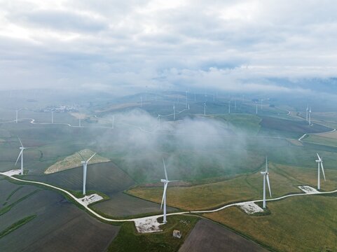 Windmills on a wind farm near Zahara de los Atunes, at a cloudy morning, aerial view, drone shot, C&aacute;diz province, Andalusia, Spain