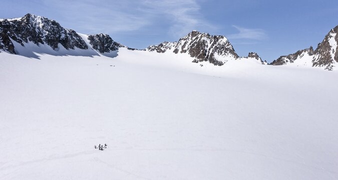 Aerial view of a group of alpinists in the high mountains with the glacier Lisener Ferner, Brunnenkogel and L&uuml;sener Spitze in the background, mountains in winter, Stubai Alps, Tyrol, Austria