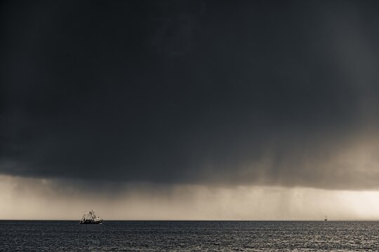Crab cutter in front of thunderstorm sky, Kampen, Sylt Island, Germany